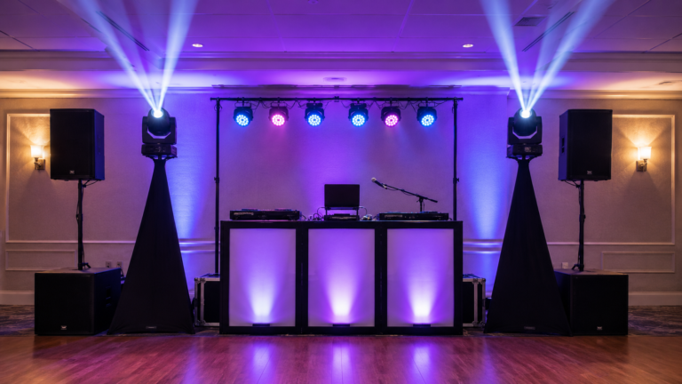 DJ moving head lights above a professional mobile event setup