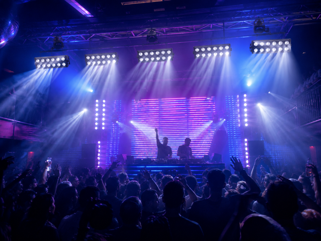 RGBW pixel strobe lights creating color and white effects in a live music venue