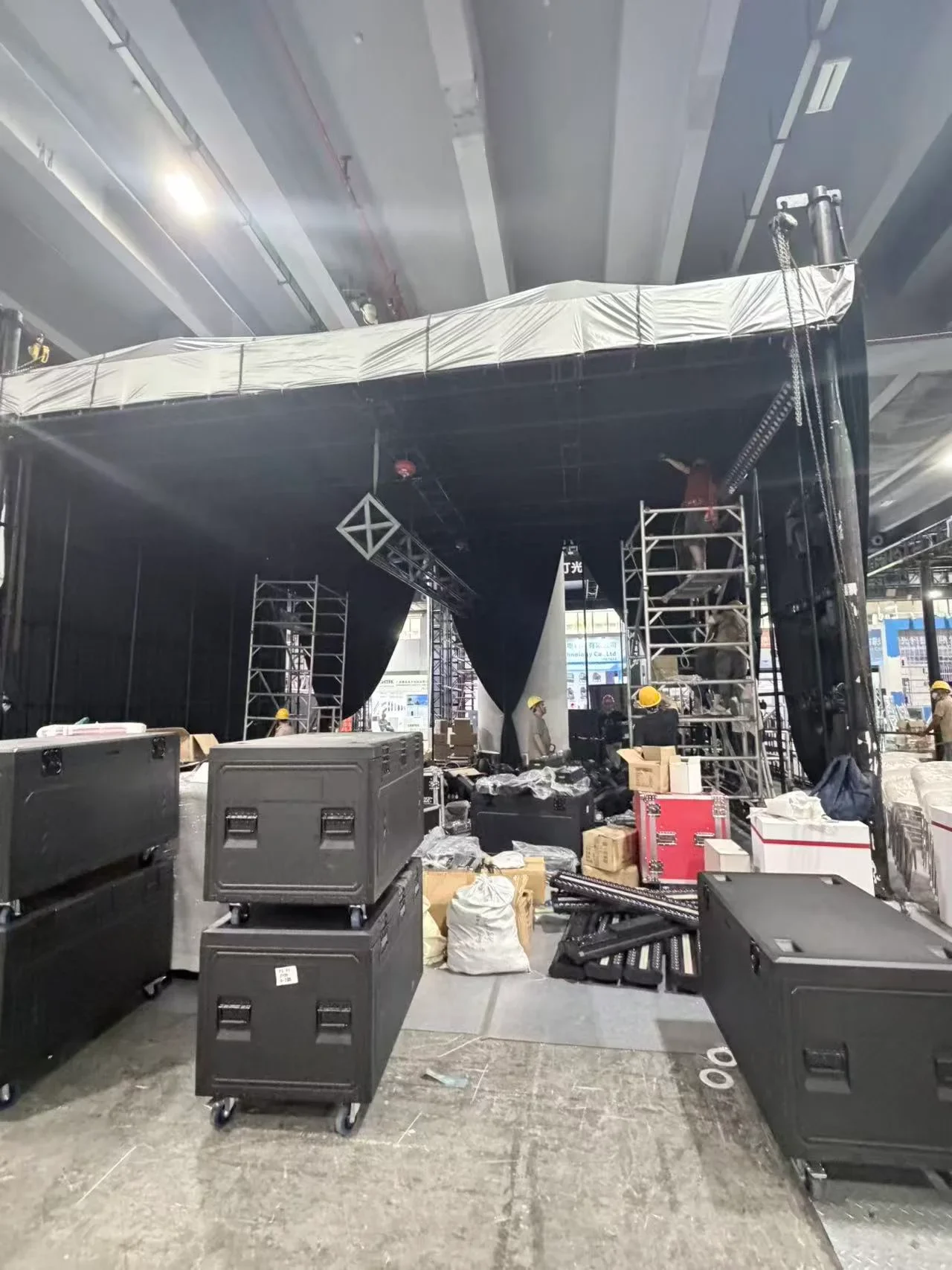 Exhibition booth under construction inside a trade-show hall.