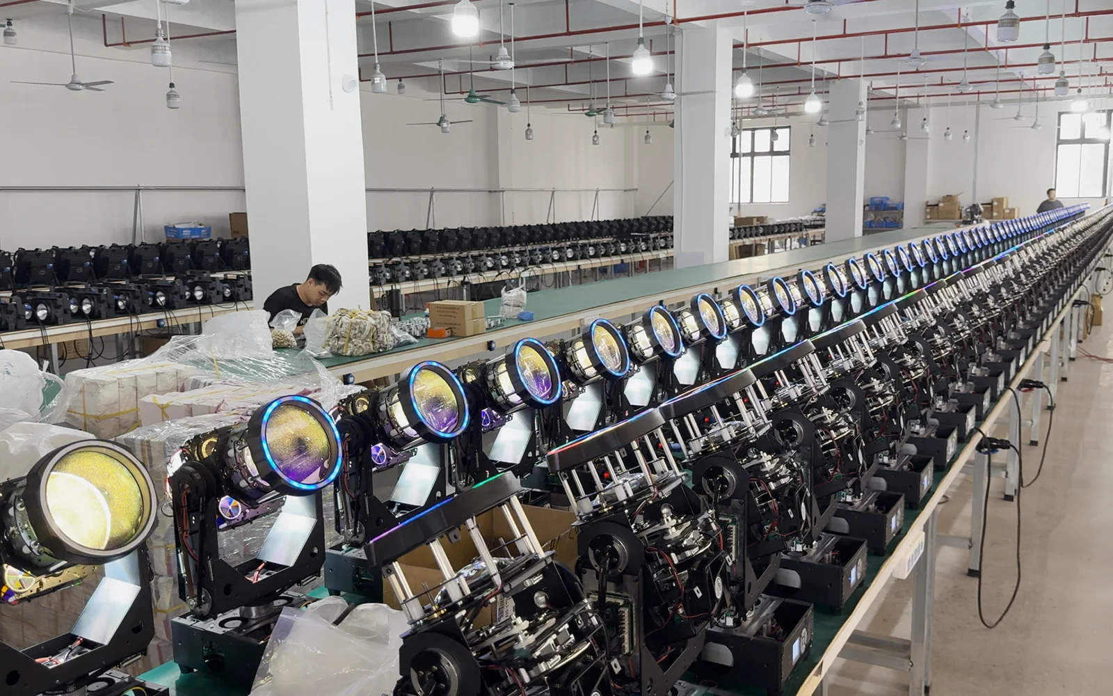 Rows of beam moving head fixtures on the workshop production line