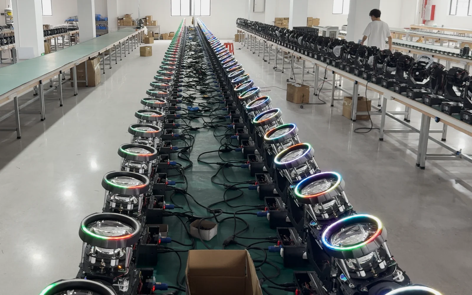 RGB-ring beam moving head fixtures lined up in the workshop