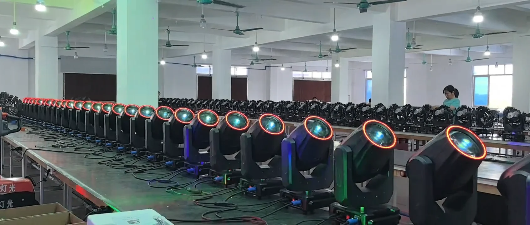 Rows of RGB-ring beam moving heads powered on during workshop production