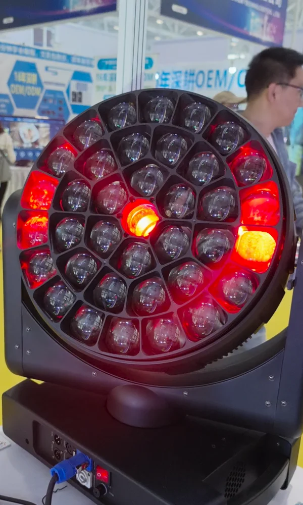 Trade-show close view of bee eye moving head with red and amber LEDs