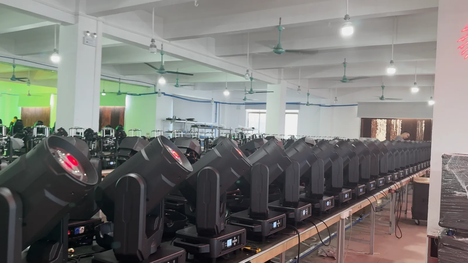 Second view of beam moving head fixtures on a workshop line