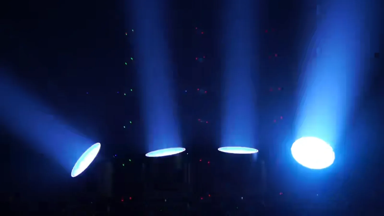 Blue wash beams from four moving head fixtures in the demonstration