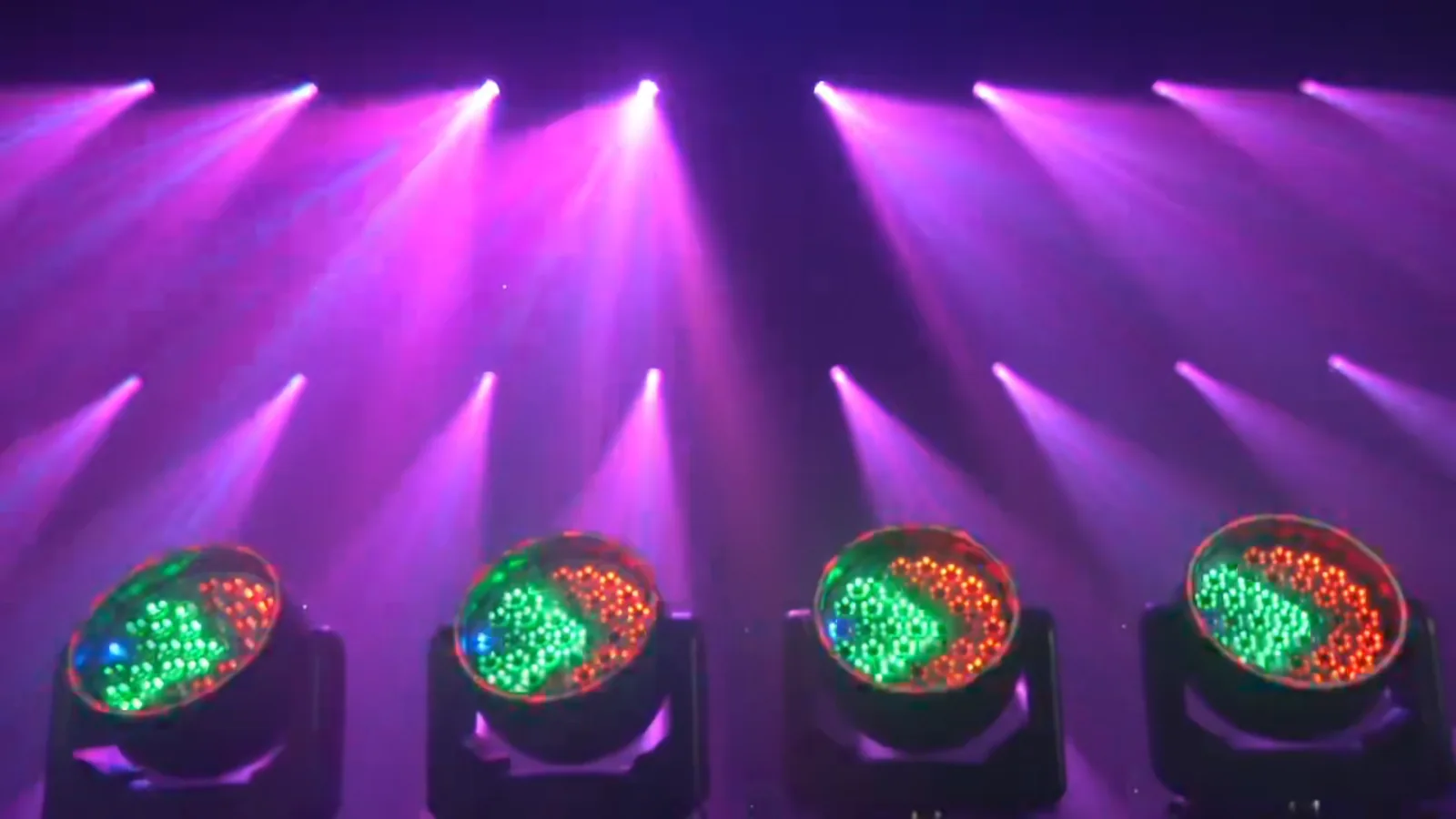 Multiple RGBW wash moving heads creating purple stage beams