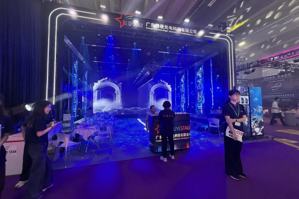 Visitors inside the illuminated WUYESTAGE booth at the 2026 Guangzhou exhibition