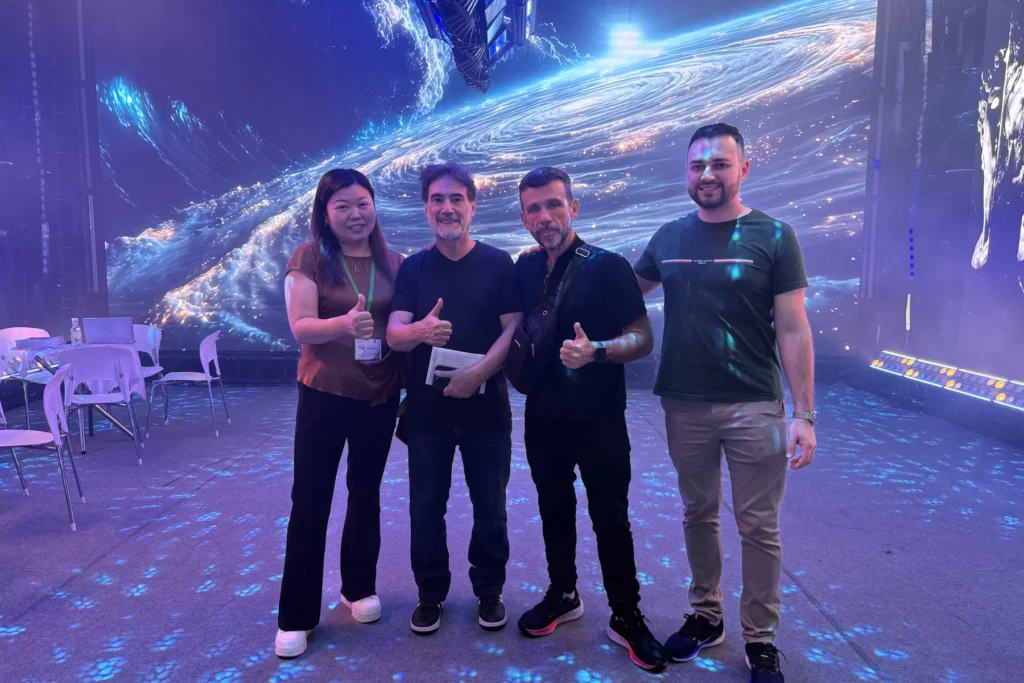 WUYESTAGE team with exhibition visitors in front of an LED display in Guangzhou