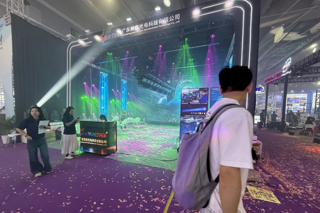 Visitors watching a stage lighting demonstration at the WUYESTAGE Guangzhou exhibition booth