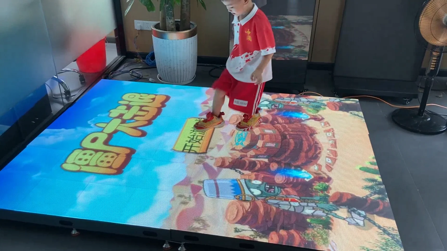 Interactive LED floor showing colorful game content during a live demonstration