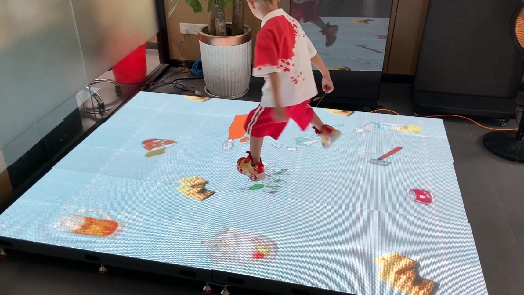 Interactive LED floor running responsive icon content during a live demonstration