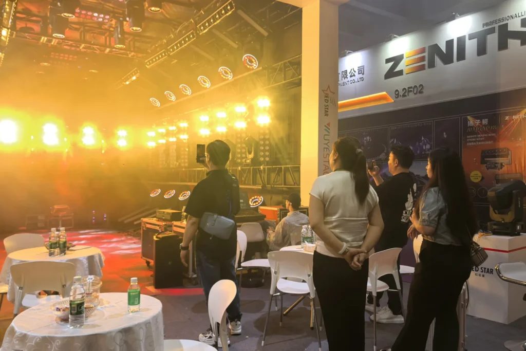 Warm white stage lighting demonstration for visitors at a WUYESTAGE exhibition