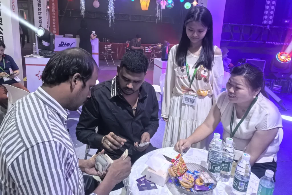 WUYESTAGE team discussing stage lighting products with an exhibition visitor