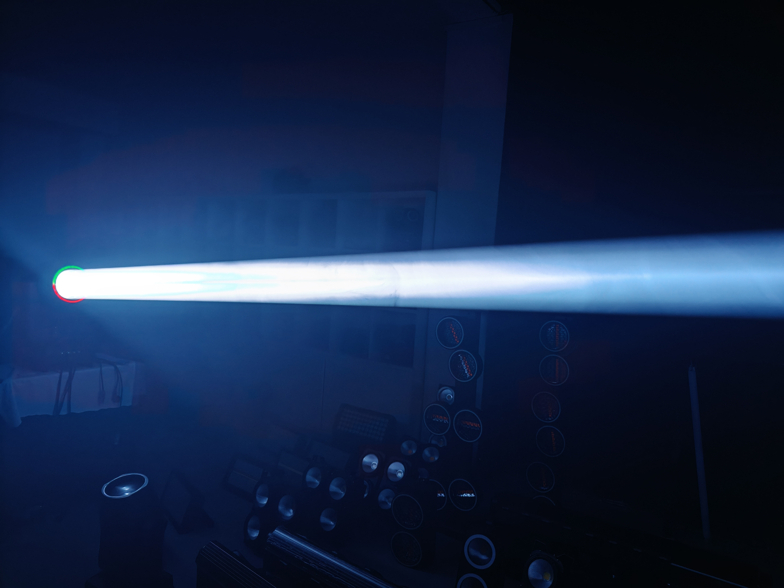 White beam photographed across a blue-lit demonstration room