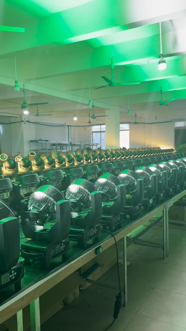 Rows of moving heads illuminated in green inside a workshop