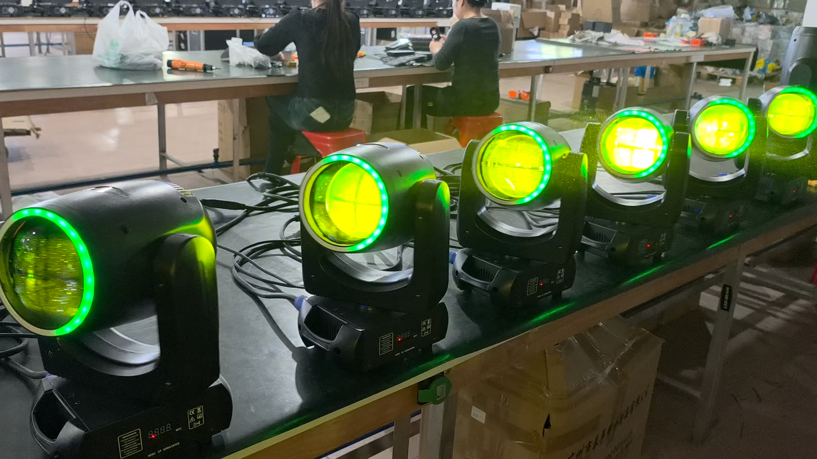 Row of fixtures with yellow-green lenses and illuminated green RGB front rings