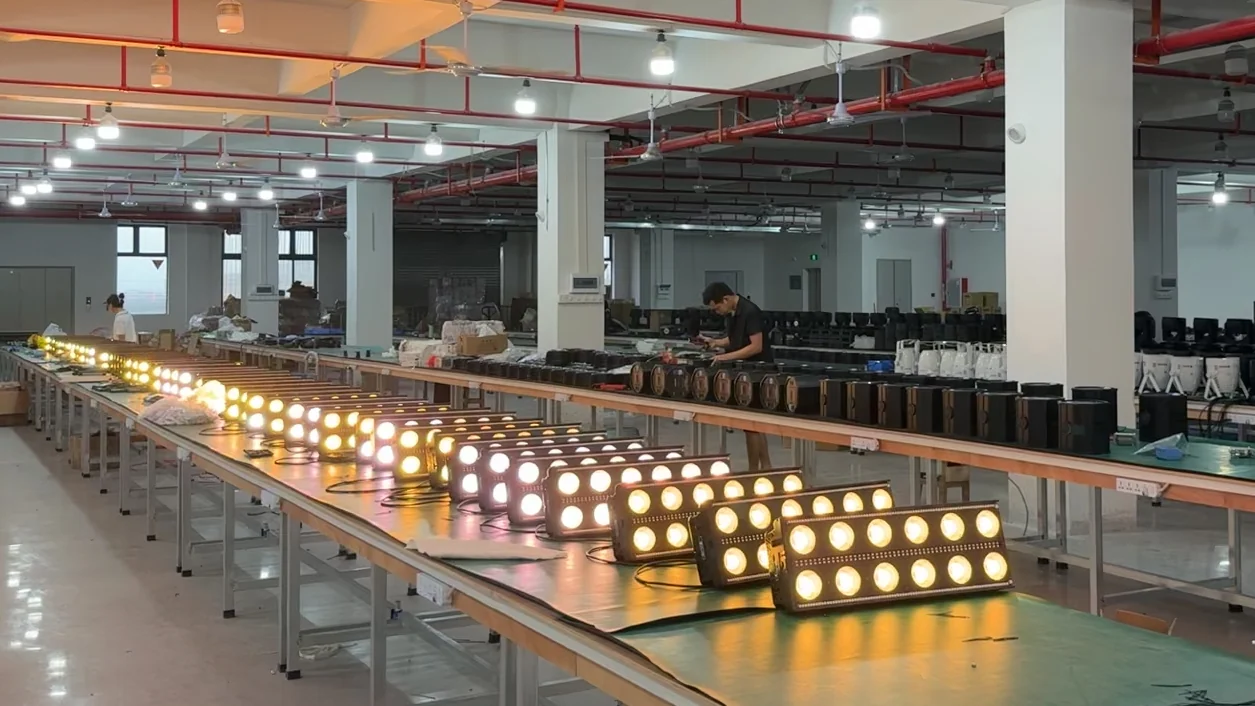 Wide workshop production line with stage effect fixtures under warm output checks