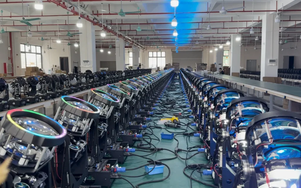 Multiple moving head lights undergoing powered function checks in the workshop