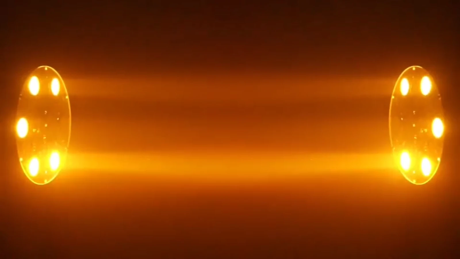 Supplied paired fixture demonstration showing warm-colored aerial light