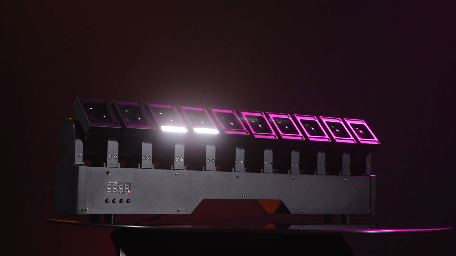 Single fixture showing pink-lit lens borders and white auxiliary strips