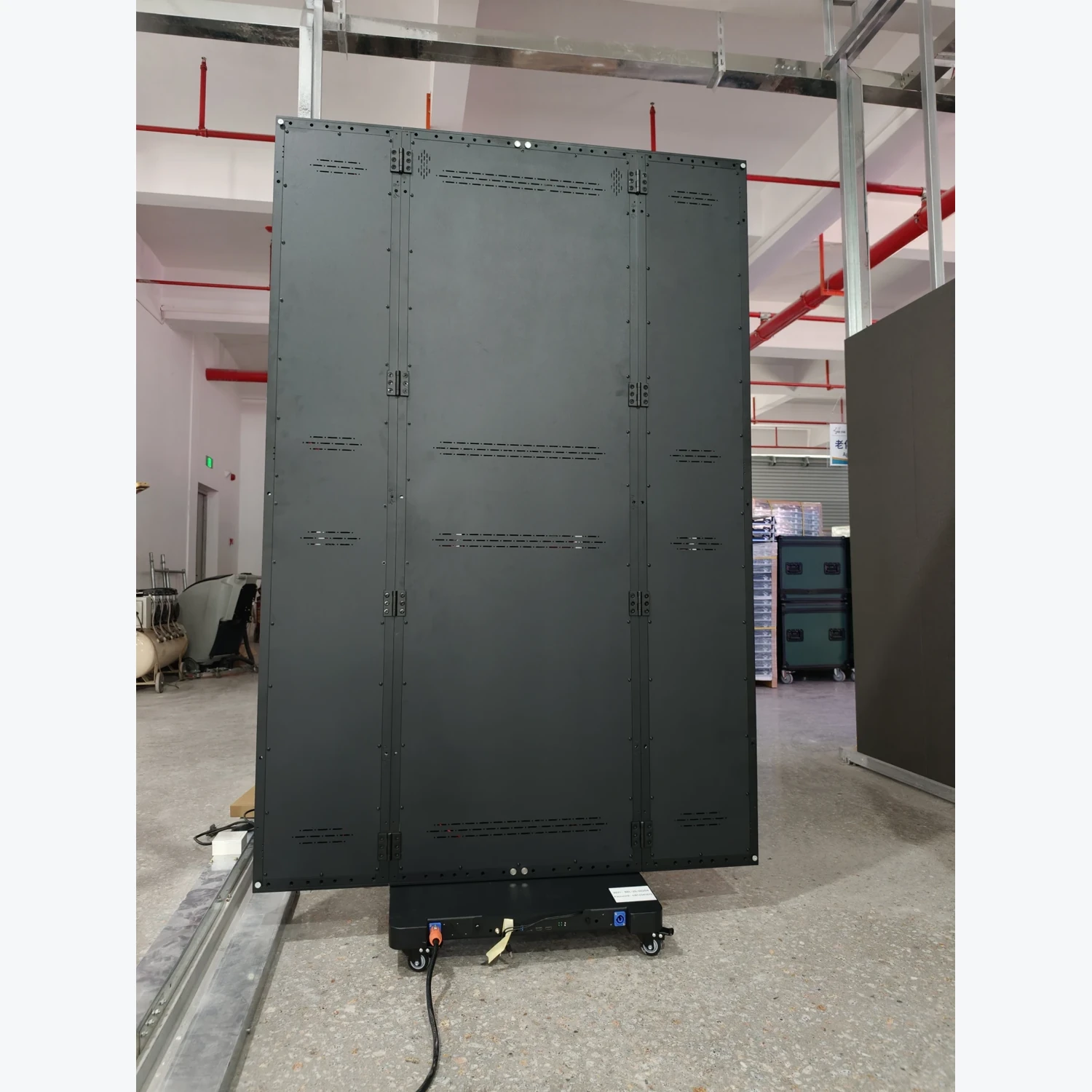 Rear view showing the LED display cabinet panels and caster base