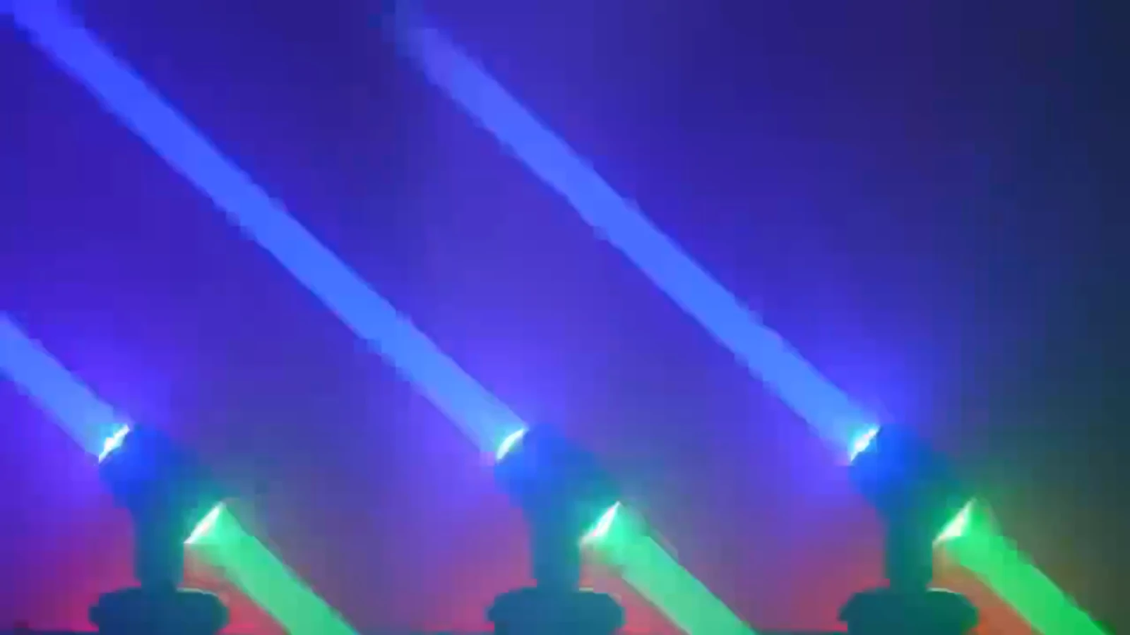 Three RG-218 fixtures producing opposing blue and green beams