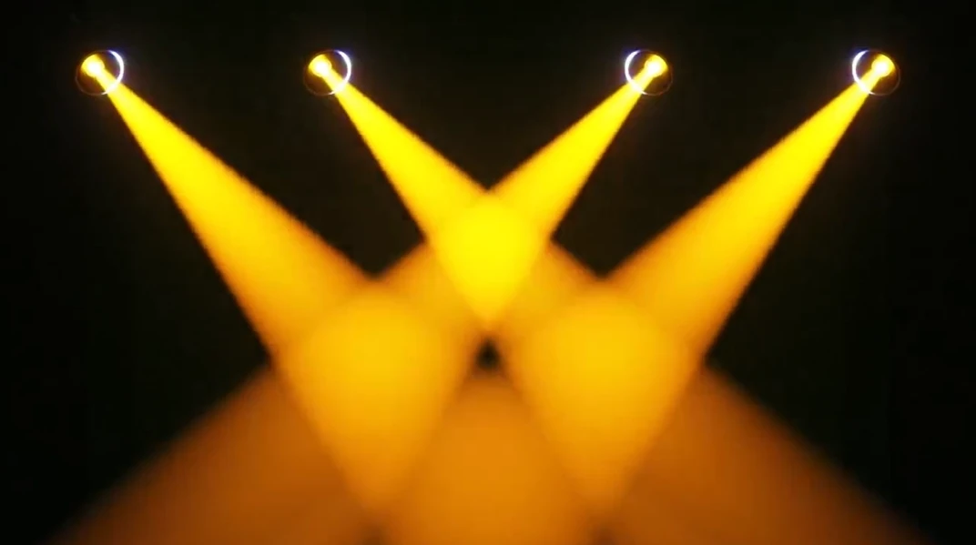 Yellow aerial light from four moving heads in a demonstration scene