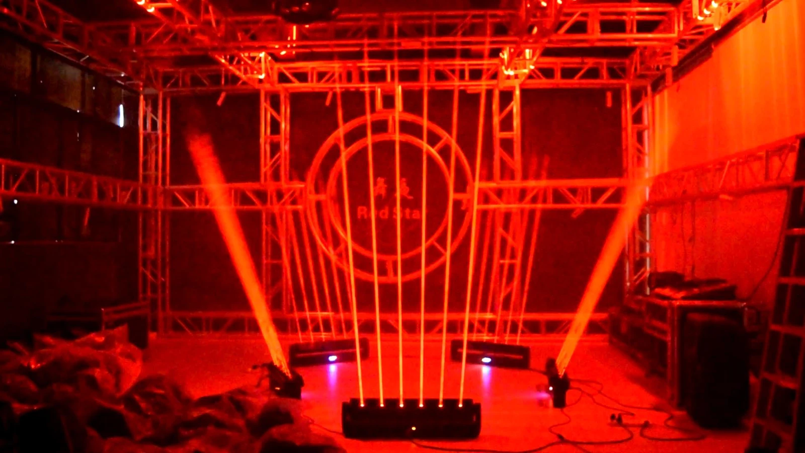 Multiple red laser bars and other luminaires in a vertical-beam demonstration