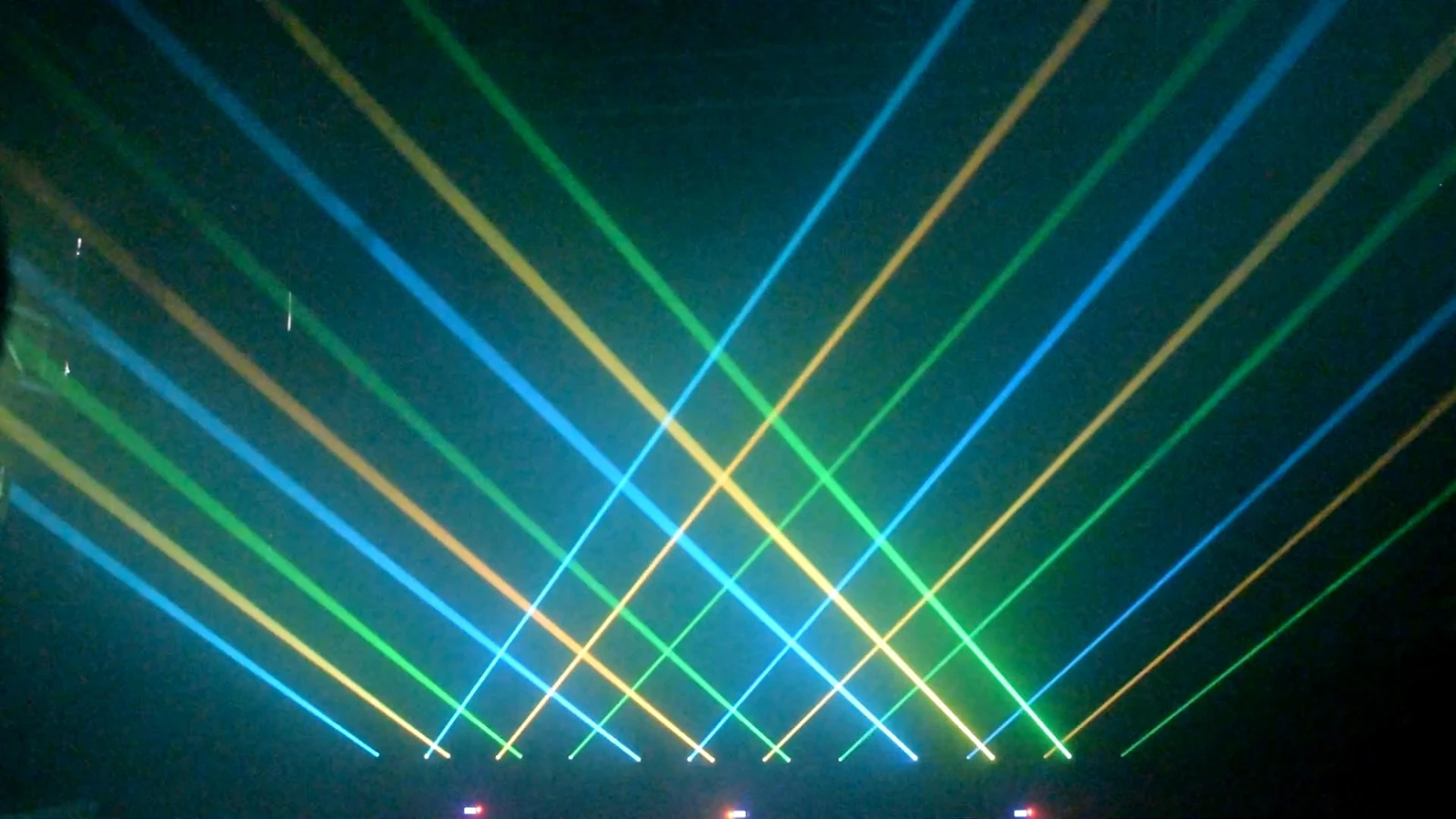 Blue green and yellow crossing beams from multiple laser bars in a demonstration