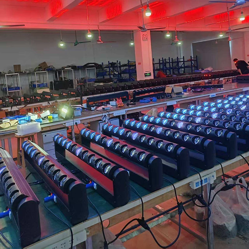 Wide workshop view of powered-on beam bars, benches and connected cables